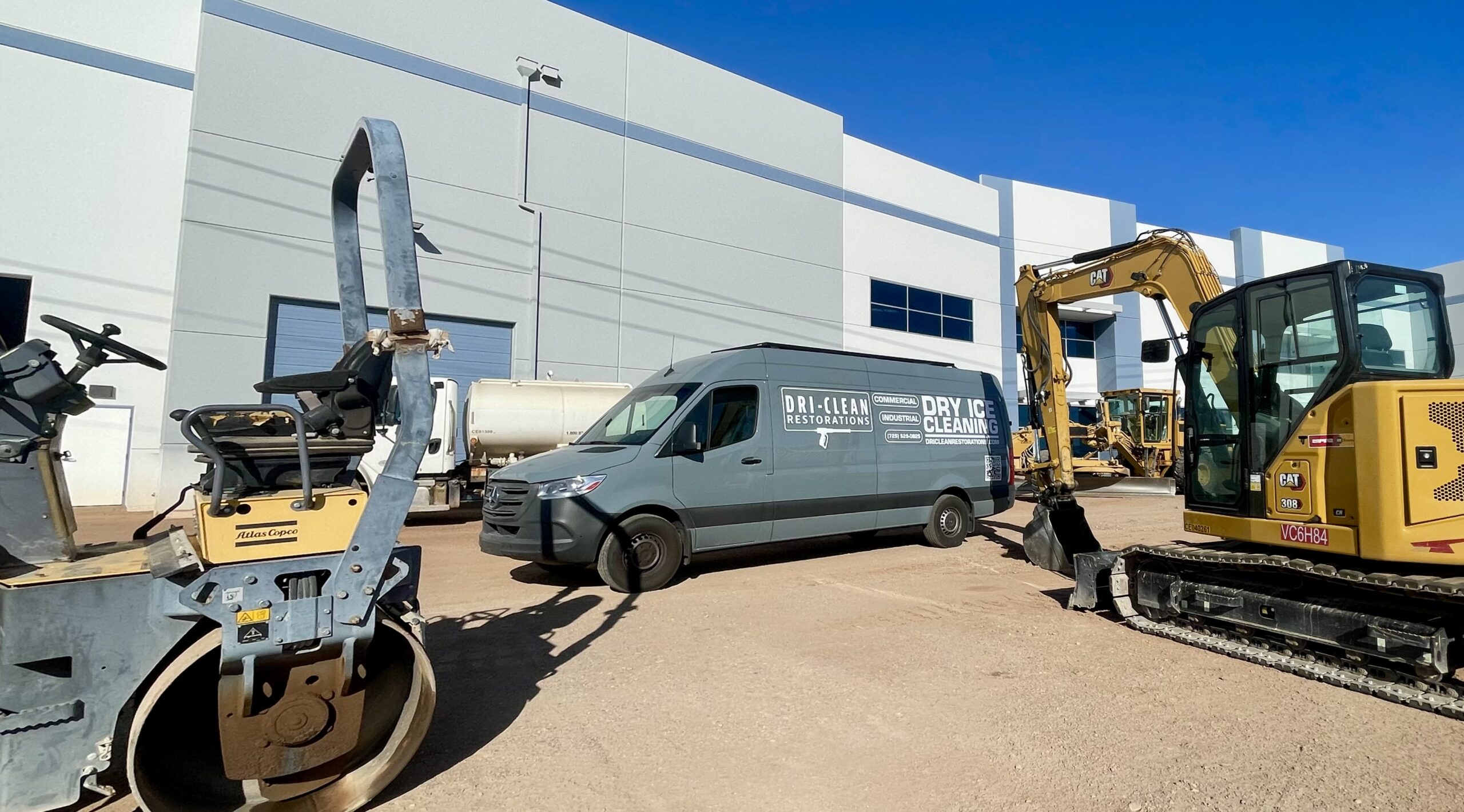 A mobile dry ice blasting vehicle from Dri-Clean Restorations, LLC at a construction site.