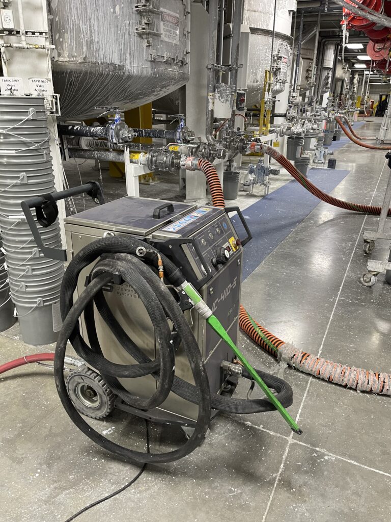 A dry ice blasting machine set up before cleaning a paint factory