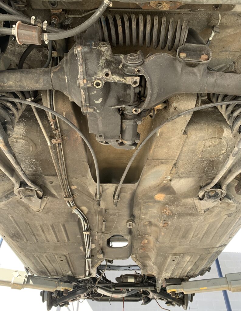 Photo before a truck's undercarriage was dry ice blasted